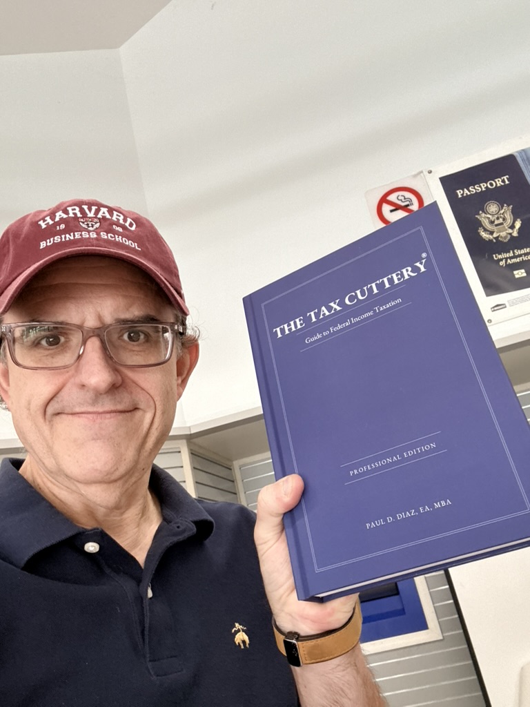 Paul Diaz holding his Professional Edition Guide to Federal Income Taxation